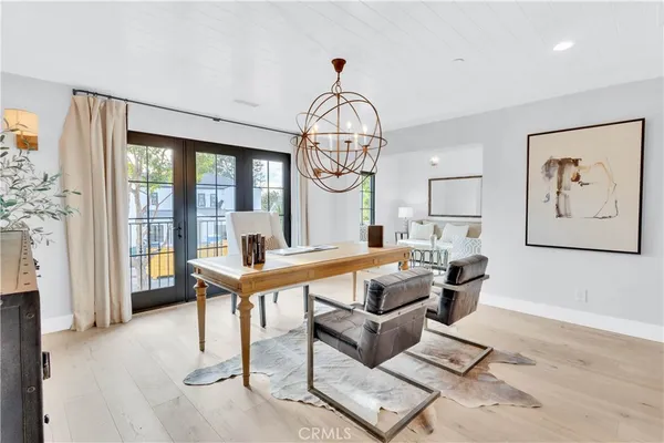 a living room with furniture a table and a large window