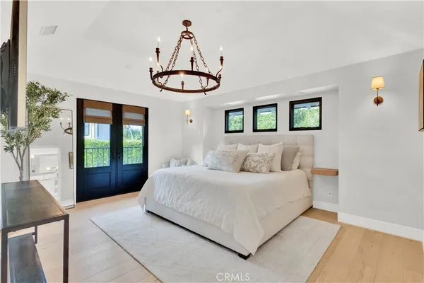 a bedroom with a large bed and a window