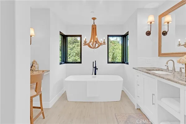 a bathroom with a double vanity sink mirror and window