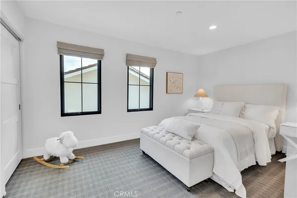 a bedroom with bed and window