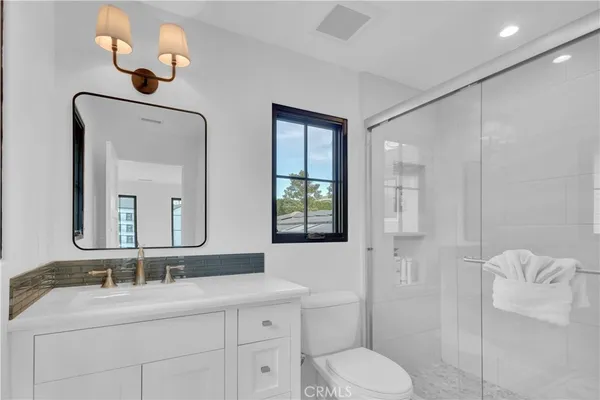 a bathroom with a toilet sink and mirror