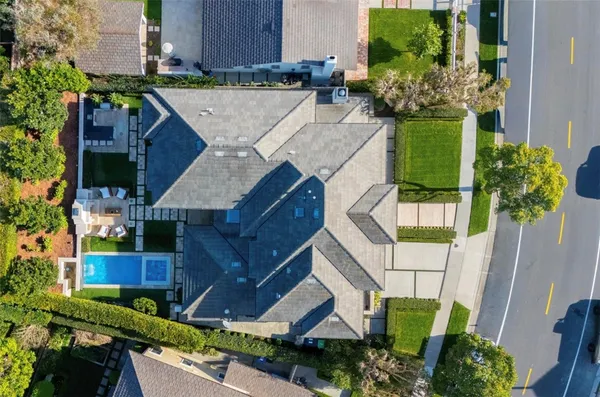 an aerial view of a house with a yard and garden