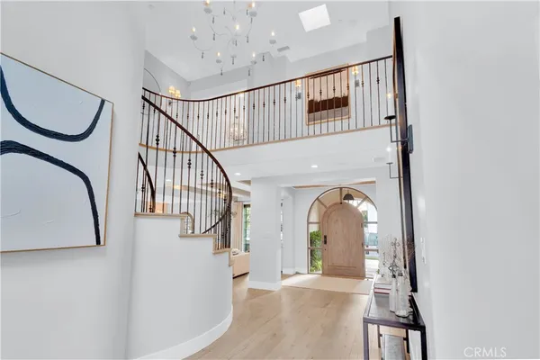 a view of a livingroom with wooden floor and a staircase