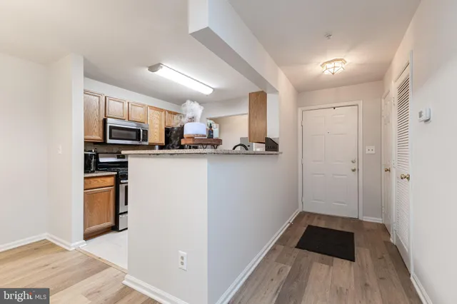 a kitchen with stainless steel appliances a refrigerator and a stove top oven