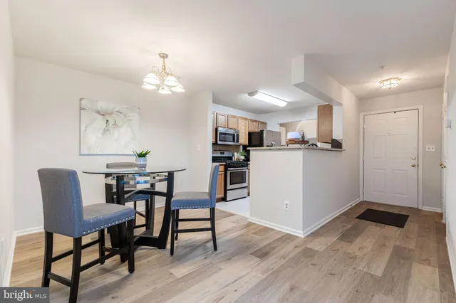 a kitchen with a table and chairs in it
