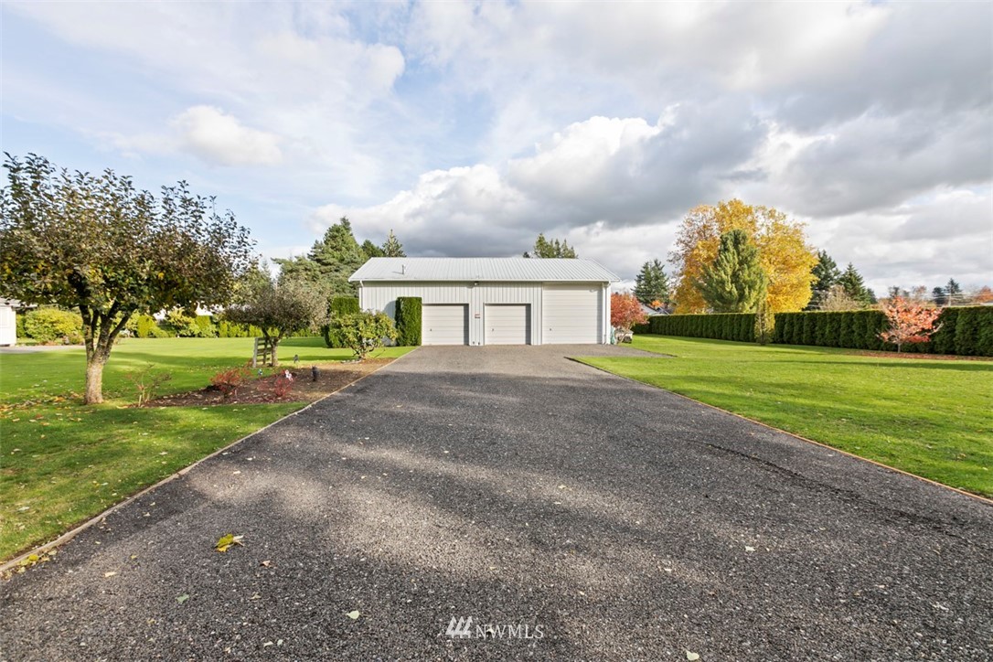 341 West Pole Road Lynden, WA 98264 - Photo 3 of 24 a view of a house with a big yard and a large trees