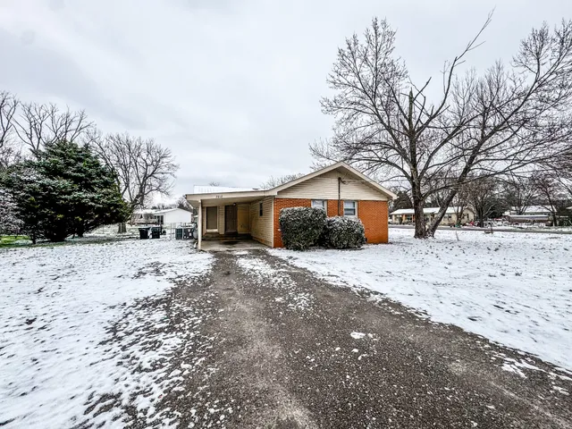 a view of house with snow on the road
