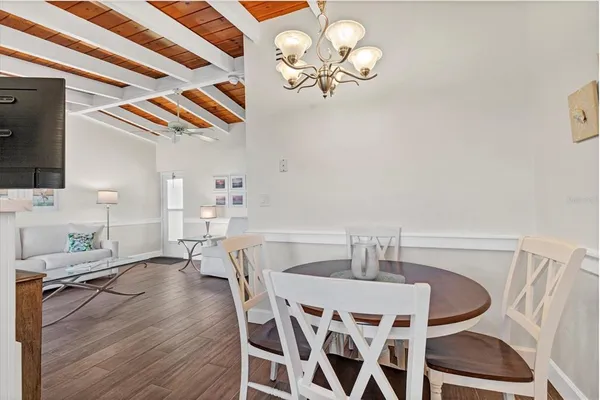 a view of a dining room with furniture and chandelier