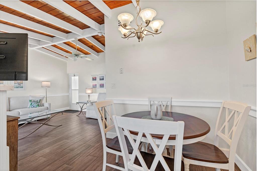 6006 Midnight Pass Road, Unit 15 Sarasota, FL 34242 - Photo 13 of 36 a view of a dining room with furniture and chandelier