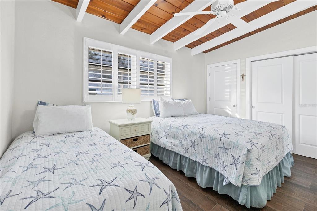 6006 Midnight Pass Road, Unit 15 Sarasota, FL 34242 - Photo 16 of 36 a bedroom with bed and a window