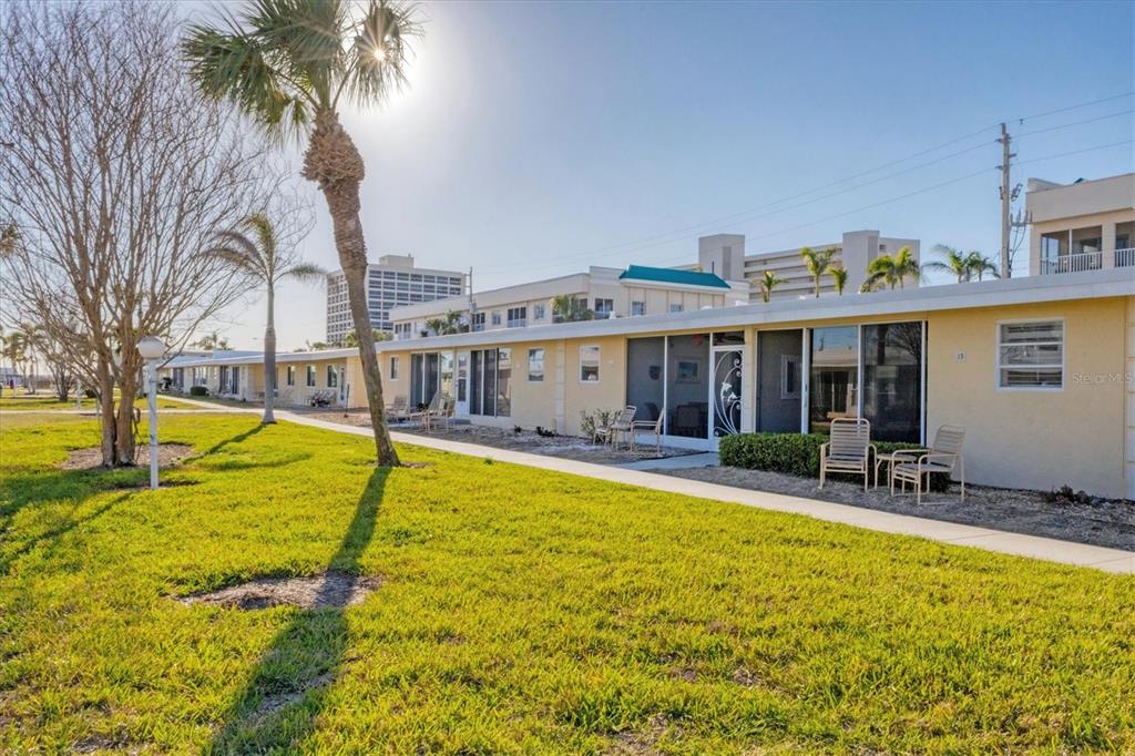 6006 Midnight Pass Road, Unit 15 Sarasota, FL 34242 - Photo 23 of 36 a view of a house with swimming pool and sitting area