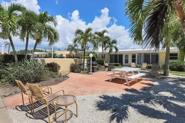a view of a swimming pool with a patio and a yard