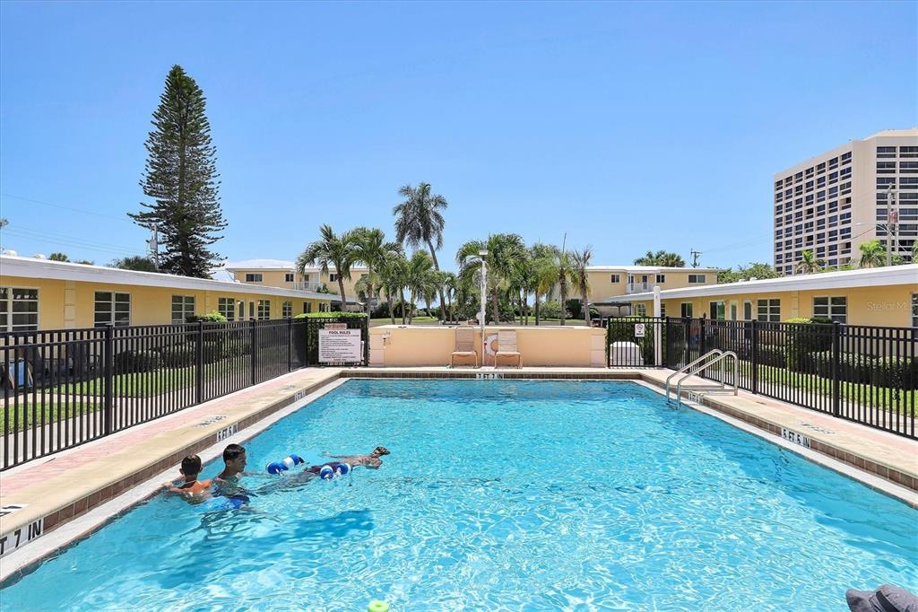 6006 Midnight Pass Road, Unit 15 Sarasota, FL 34242 - Photo 28 of 36 a view of a swimming pool with a patio and mountain view