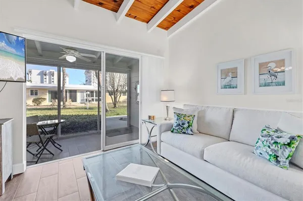 a living room with furniture and a floor to ceiling window