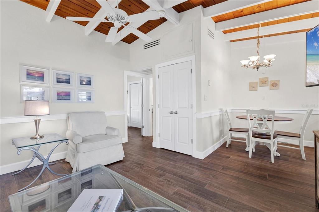 6006 Midnight Pass Road, Unit 15 Sarasota, FL 34242 - Photo 9 of 36 a living room with furniture and a wooden floor
