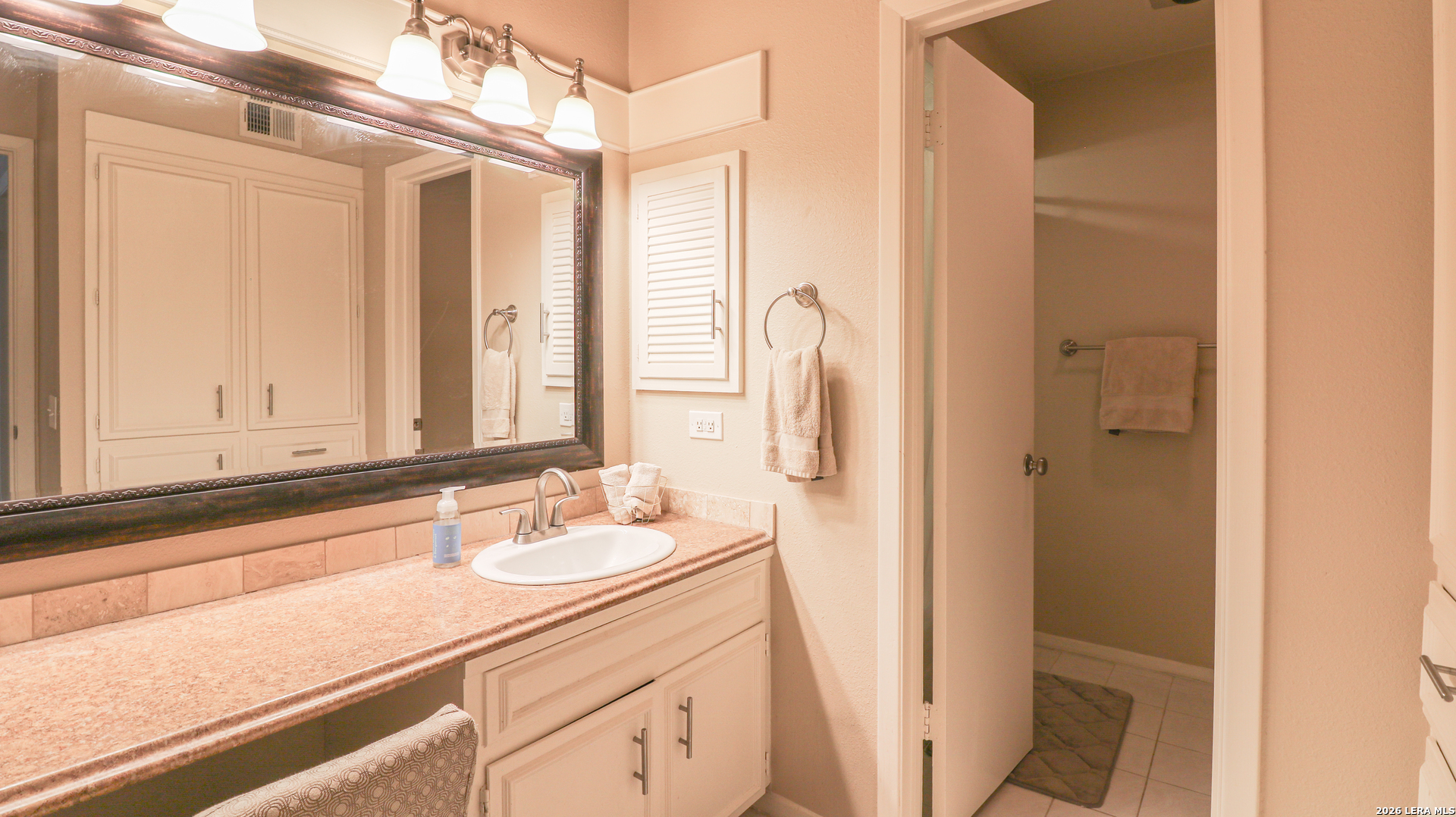 7500 Callaghan Road, Unit 236 San Antonio, TX 78229 - Photo 13 of 19 a bathroom with a sink a mirror and a shower