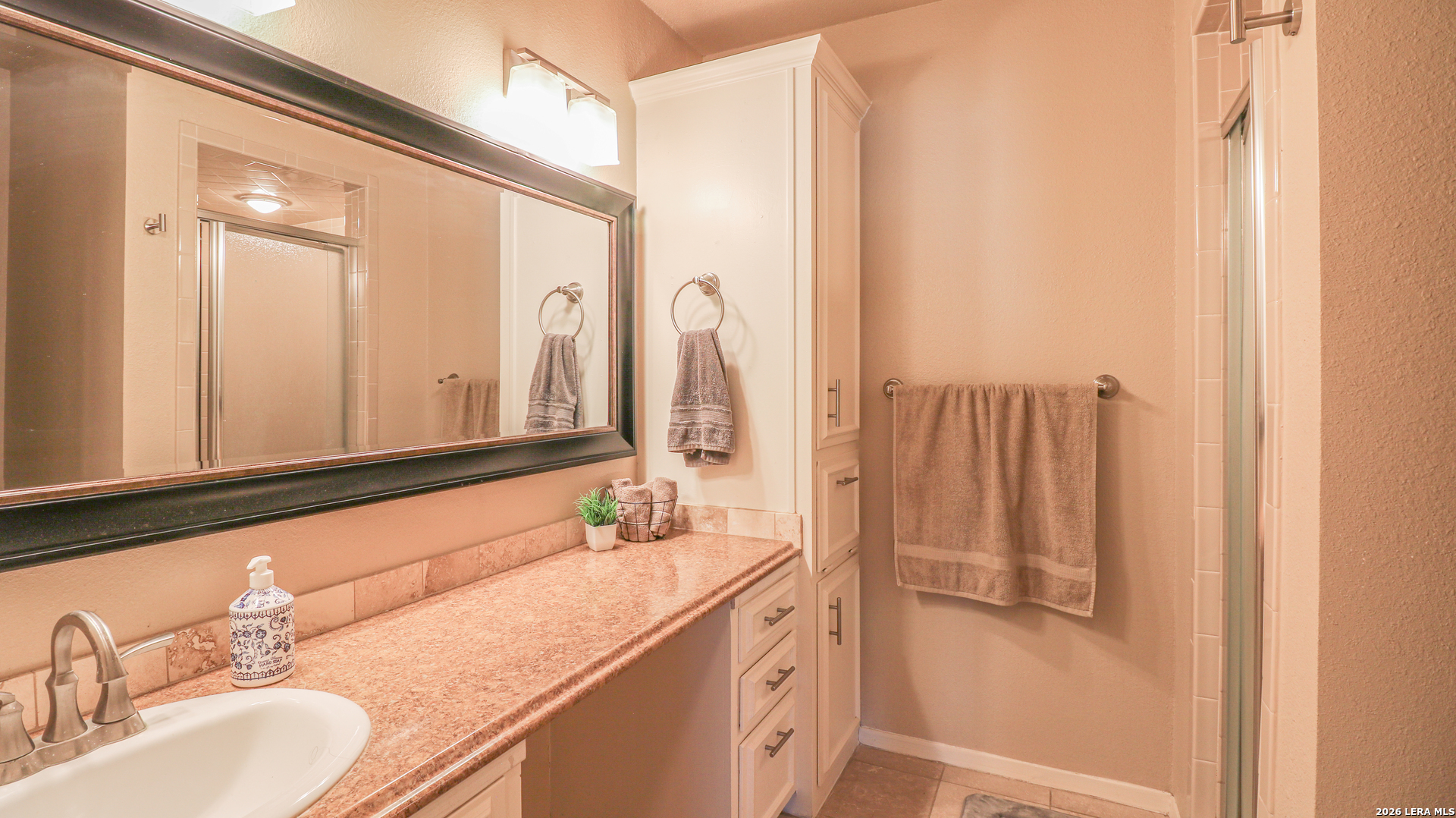 7500 Callaghan Road, Unit 236 San Antonio, TX 78229 - Photo 16 of 19 a bathroom with a double vanity sink and a mirror