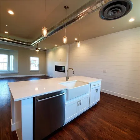 a kitchen with kitchen island a stove and a refrigerator