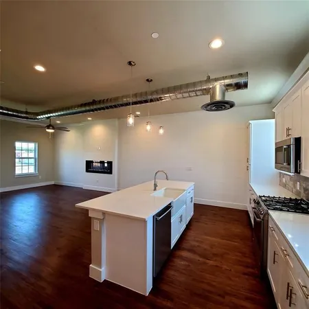 a kitchen with sink and stove