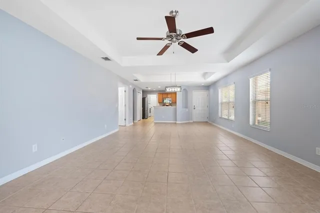 a view of a livingroom with a ceiling fan and window