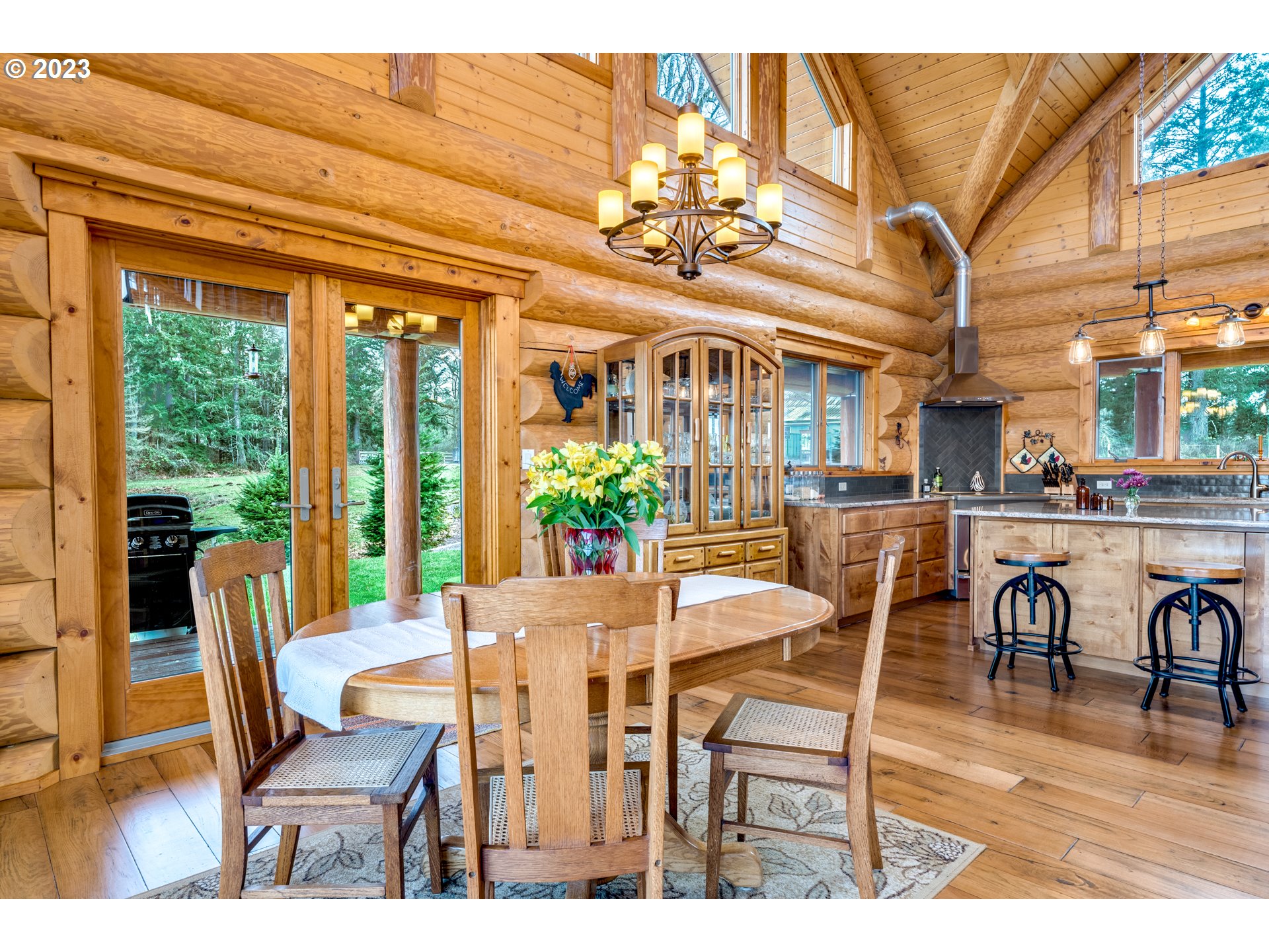 14115 South Leabo Road Molalla, OR 97038 - Photo 8 of 32 a dining room with furniture a chandelier and wooden floor