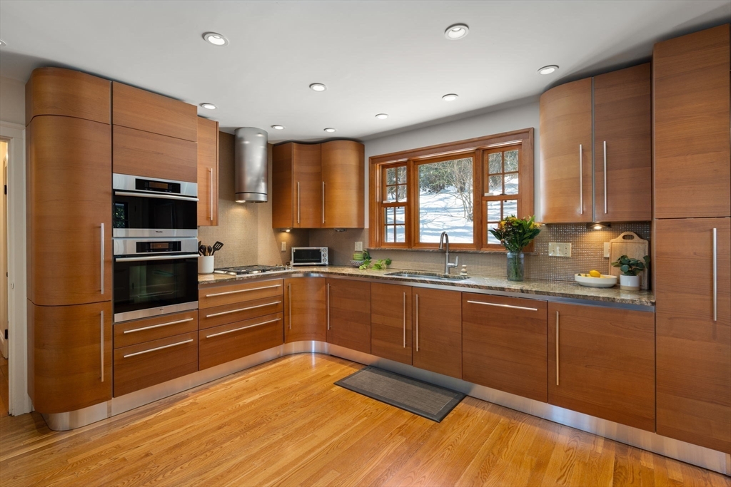 36 Goodnough Road Brookline, MA 02467 - Photo 12 of 31 a kitchen with granite countertop a stove a sink and a refrigerator
