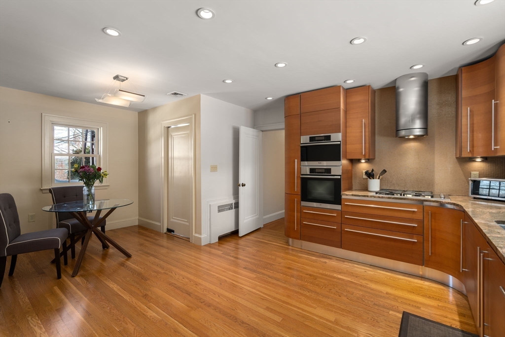 36 Goodnough Road Brookline, MA 02467 - Photo 13 of 31 a kitchen with stainless steel appliances a refrigerator and wooden floor