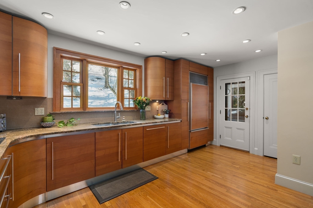 36 Goodnough Road Brookline, MA 02467 - Photo 14 of 31 a kitchen with stainless steel appliances granite countertop a sink stove and wooden cabinets