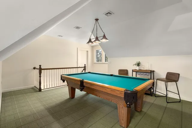 a room with pool table and windows