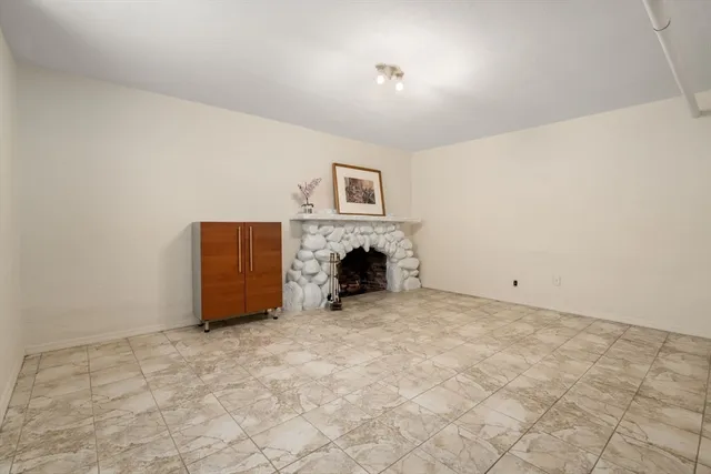 a view of empty room with a fireplace