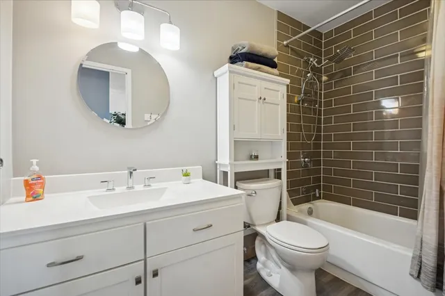 a bathroom with a sink toilet and shower