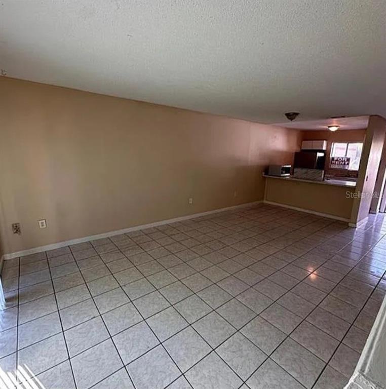 5869 Curry Ford Road Orlando, FL 32822 - Photo 2 of 10 a living room with a couch