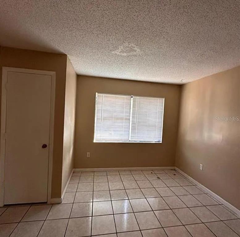 5869 Curry Ford Road Orlando, FL 32822 - Photo 6 of 10 an empty room with windows