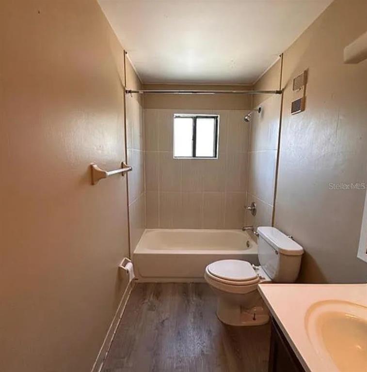 5869 Curry Ford Road Orlando, FL 32822 - Photo 8 of 10 a bathroom with a sink a toilet and a bathtub