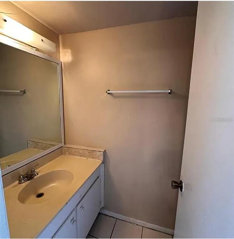 5869 Curry Ford Road Orlando, FL 32822 - Photo 9 of 10 a bathroom with a sink and shower