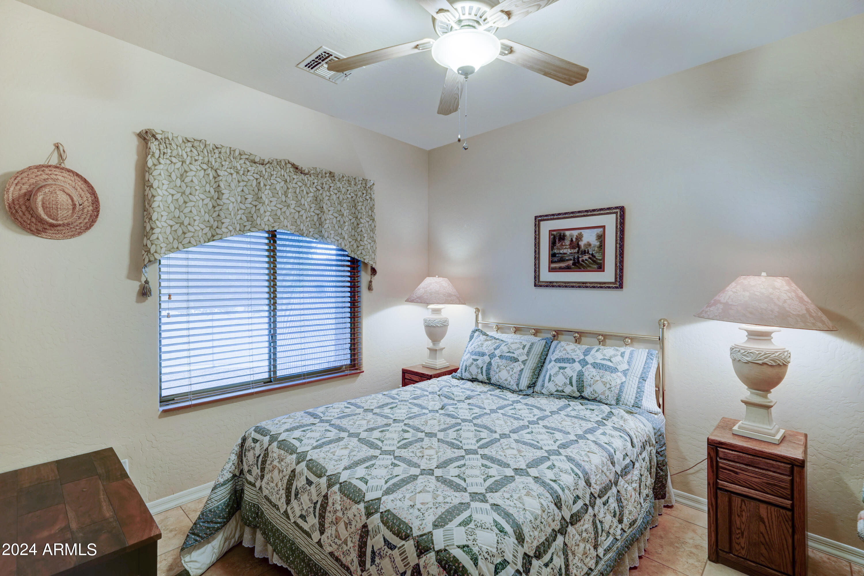 2101 South Meridian Road, Unit 126 Apache Junction, AZ 85120 - Photo 15 of 58 a bedroom with a bed and a chandelier