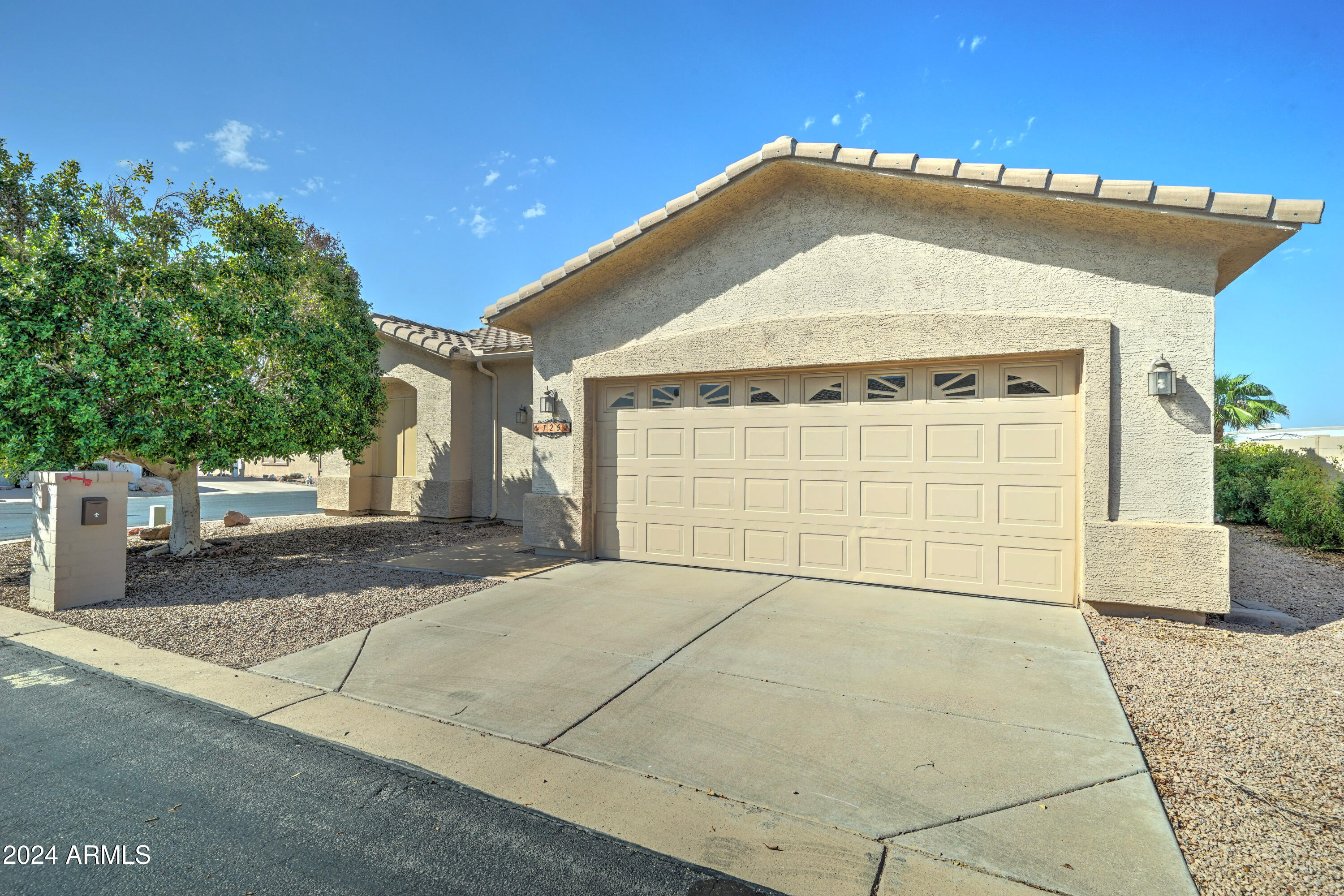 2101 South Meridian Road, Unit 126 Apache Junction, AZ 85120 - Photo 2 of 58 a front view of a house with a garage
