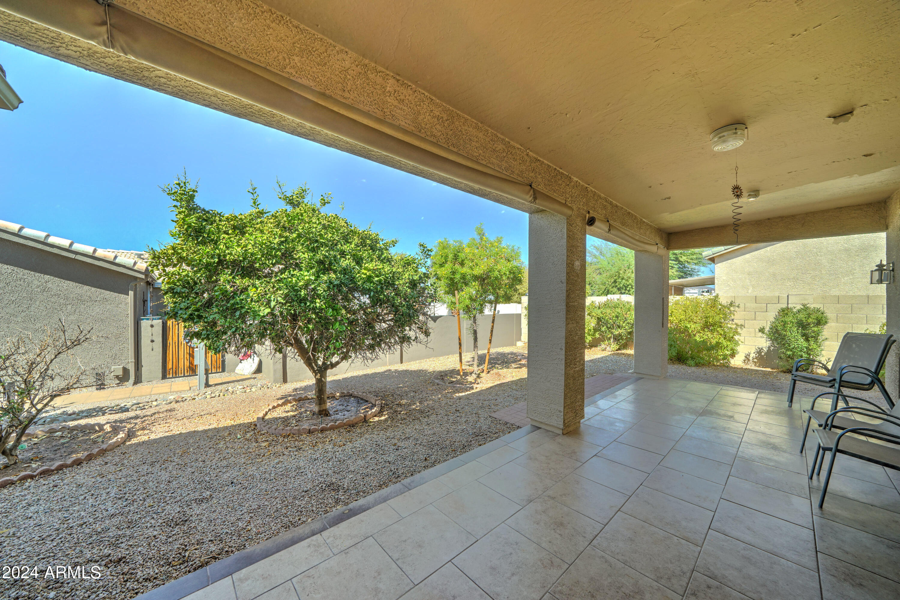 2101 South Meridian Road, Unit 126 Apache Junction, AZ 85120 - Photo 25 of 58 a view of a porch with chairs and floor to ceiling window