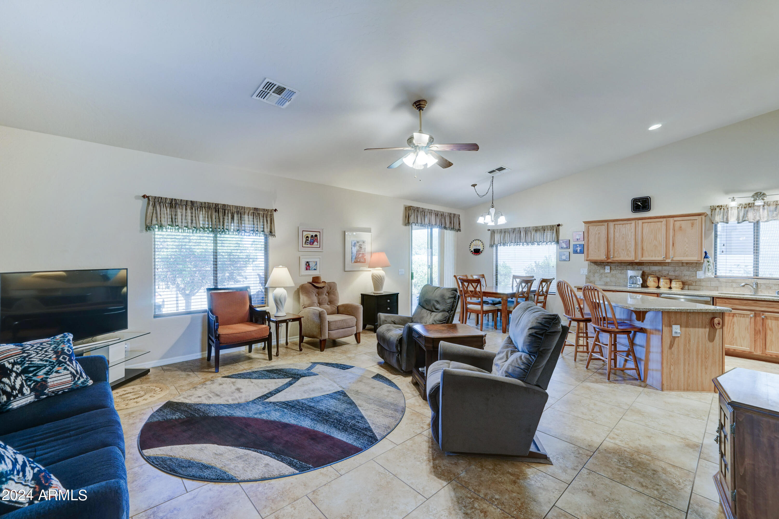 2101 South Meridian Road, Unit 126 Apache Junction, AZ 85120 - Photo 6 of 58 a living room with furniture kitchen view and a flat screen tv