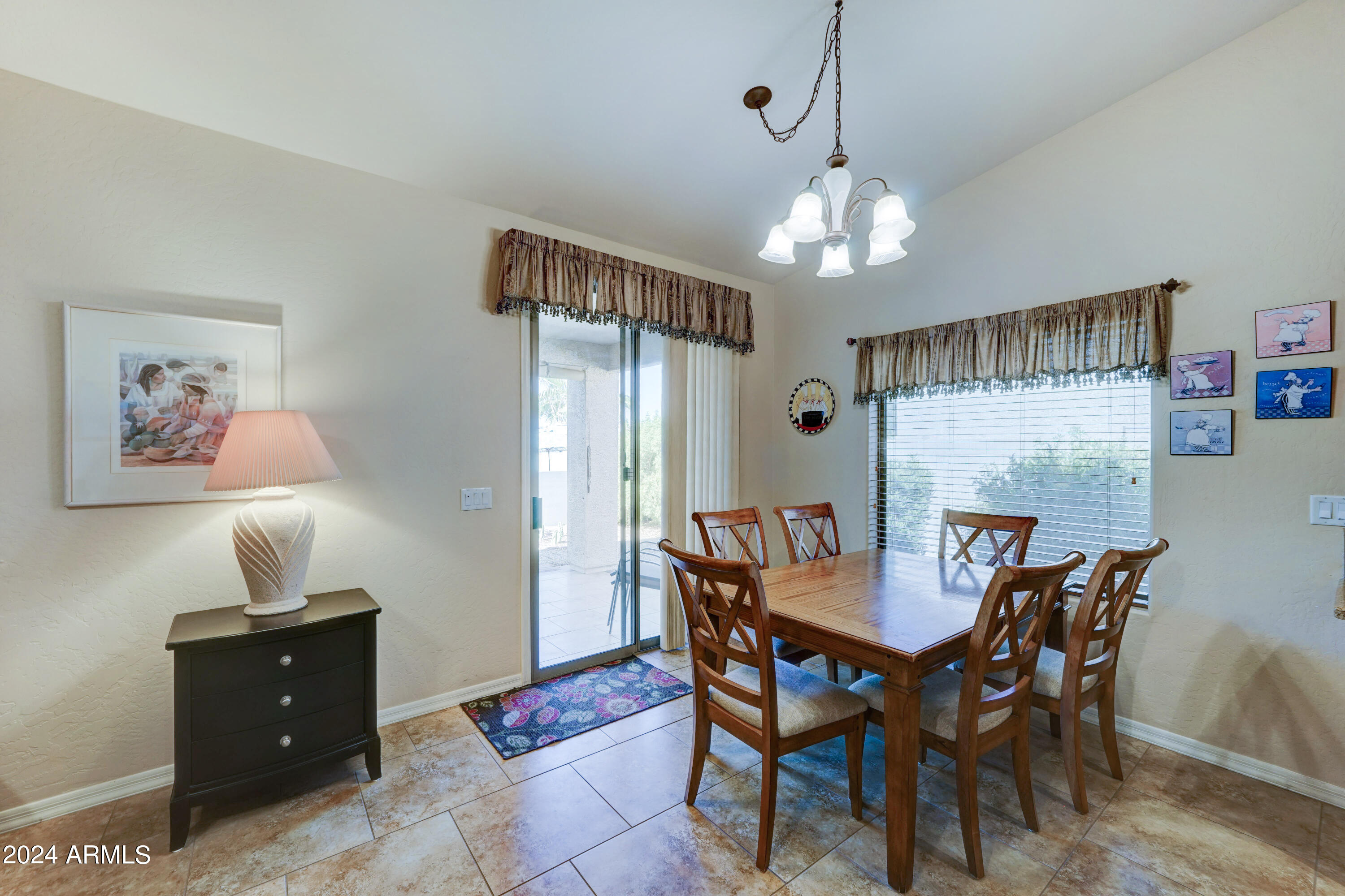 2101 South Meridian Road, Unit 126 Apache Junction, AZ 85120 - Photo 7 of 58 a view of a dining room with furniture a chandelier and wooden floor