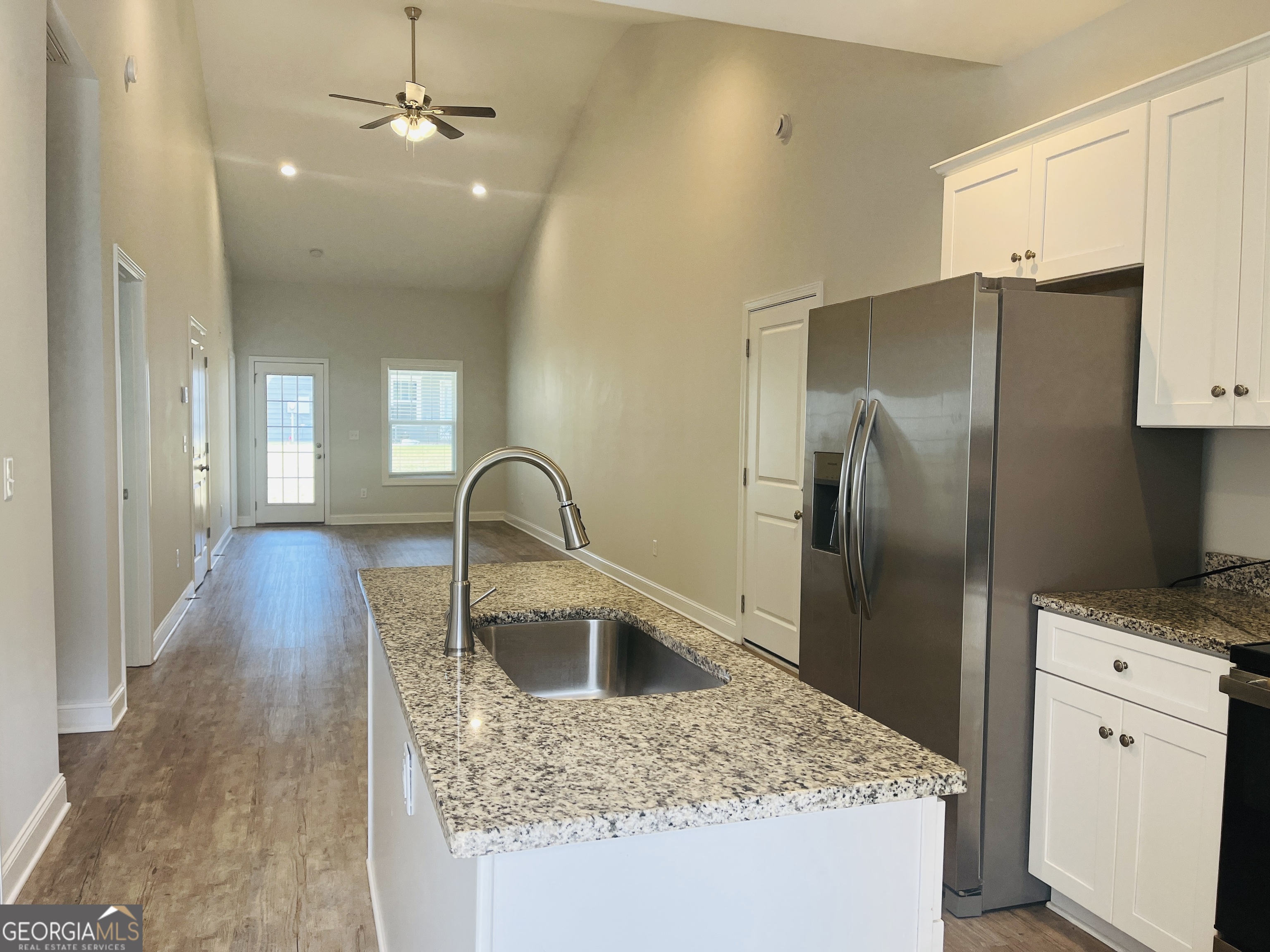 110 Lenox Circle LaGrange, GA 30241 - Photo 3 of 23 a kitchen with stainless steel appliances granite countertop a refrigerator a sink a stove and white cabinets with wooden floor