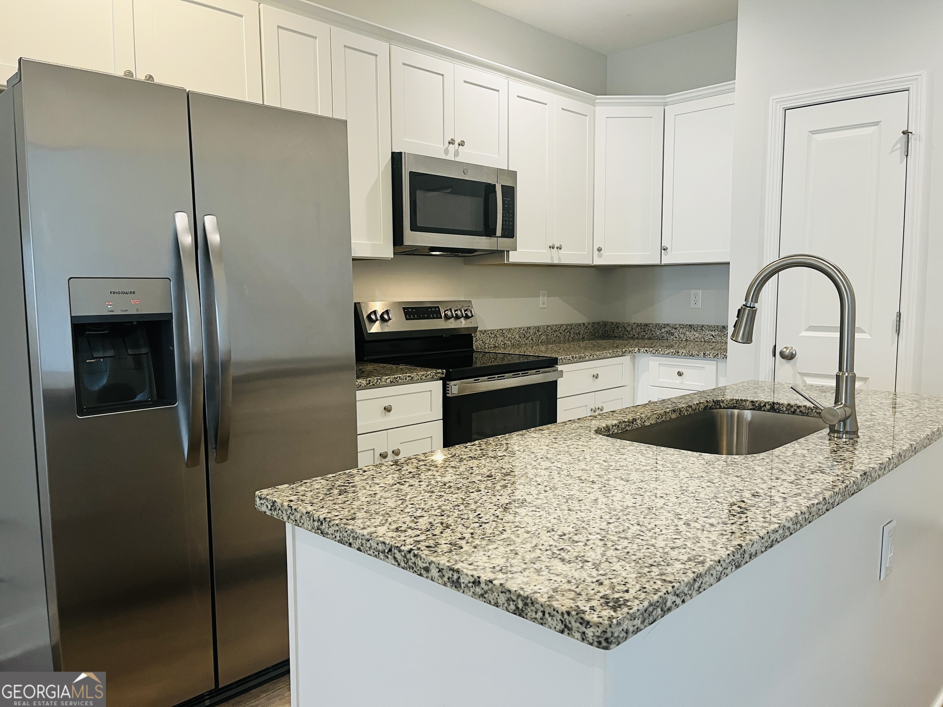 110 Lenox Circle LaGrange, GA 30241 - Photo 8 of 23 a kitchen with stainless steel appliances granite countertop a refrigerator a stove a sink and a white cabinets