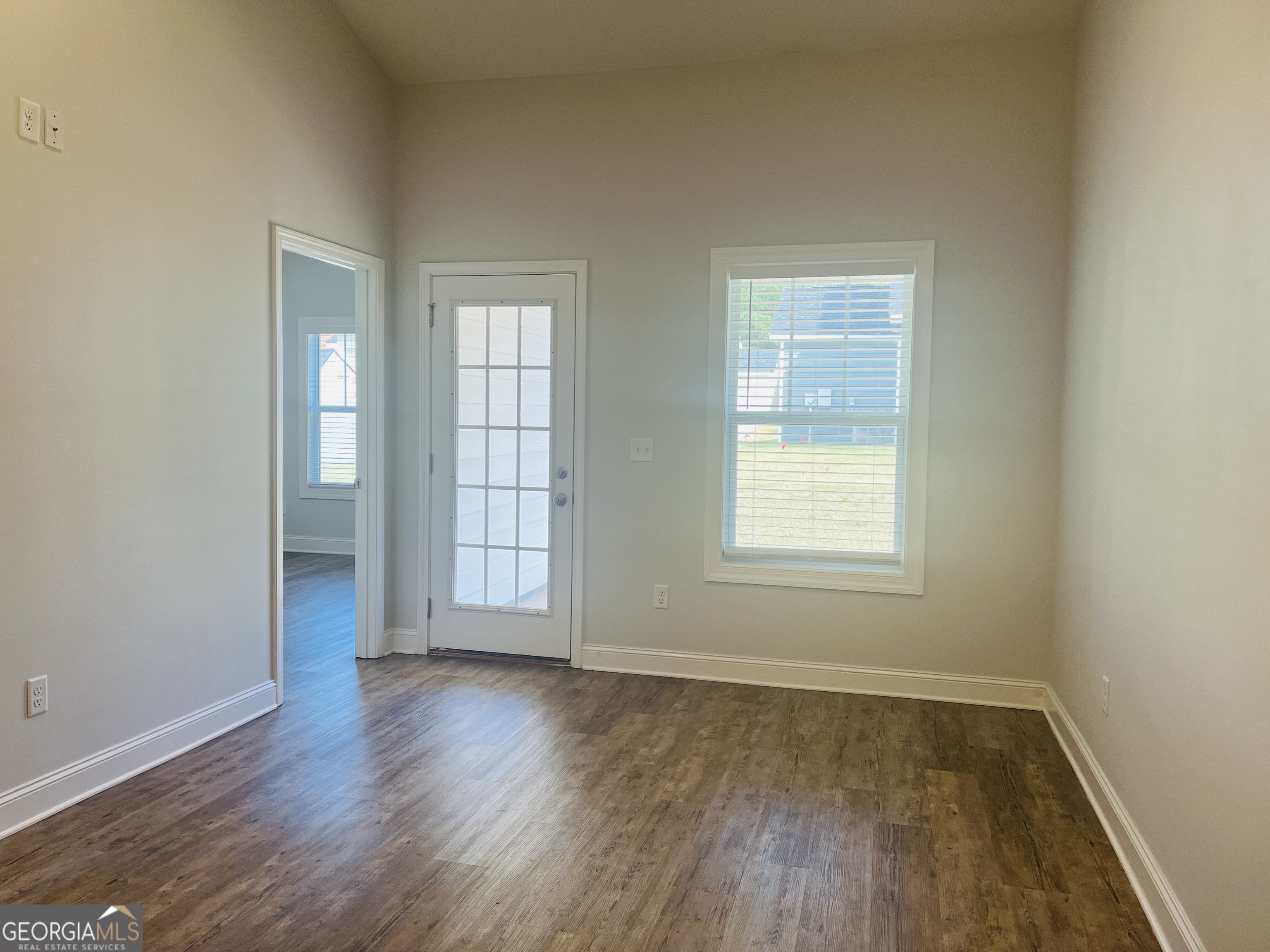110 Lenox Circle LaGrange, GA 30241 - Photo 10 of 23 an empty room with wooden floor and windows