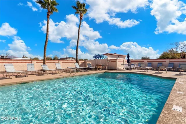 a view of a swimming pool and lounge chairs