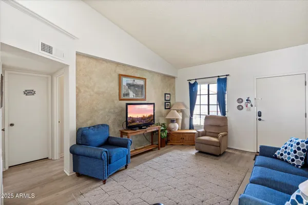 a living room with furniture a rug and a window