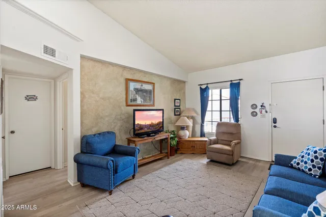 a living room with furniture a rug and a window