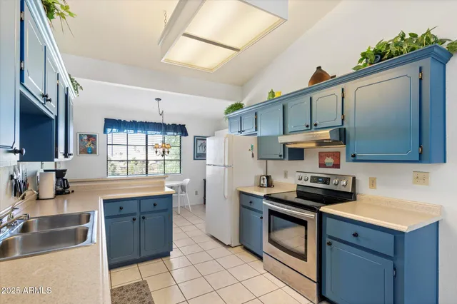 a kitchen with a sink a stove and cabinets
