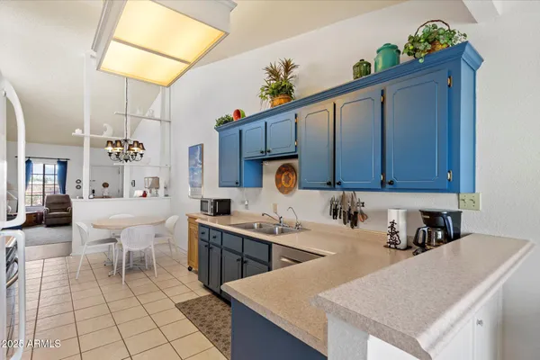 a kitchen with a sink a microwave and cabinets