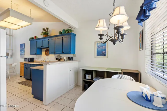 a kitchen that has a lot of cabinets and stainless steel appliances
