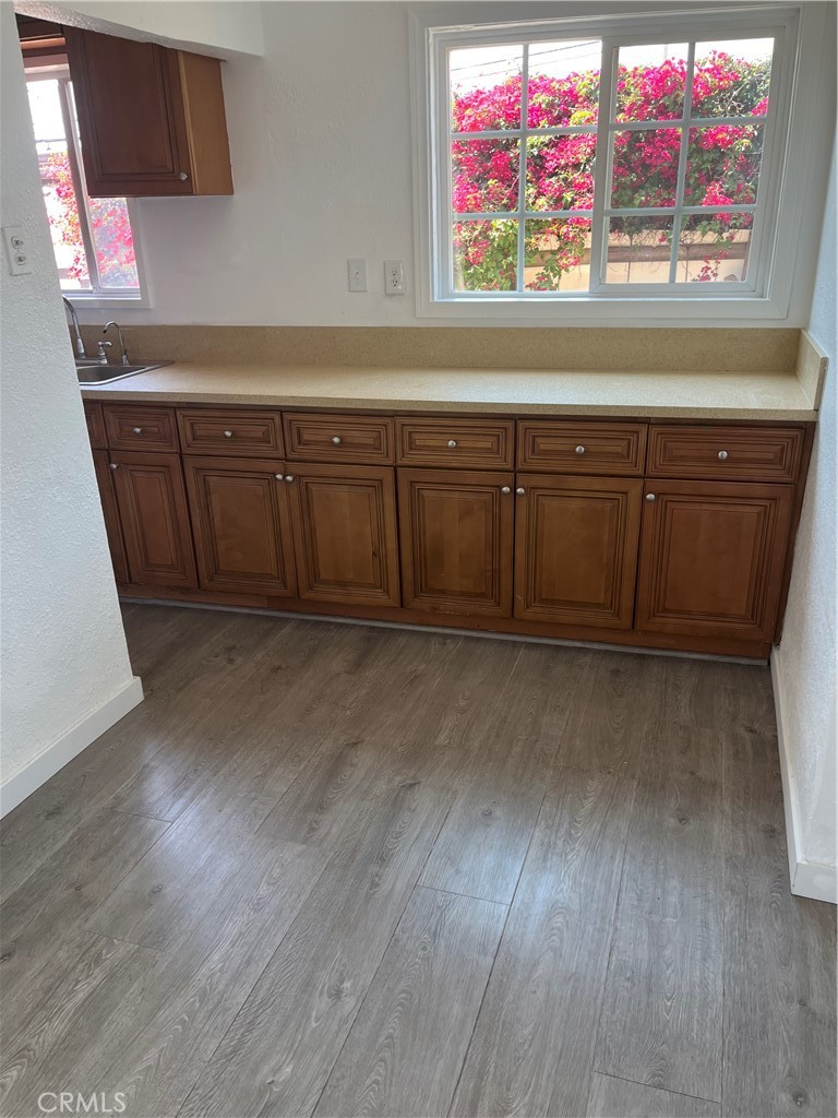 a view of a room with wooden floor and cabinet